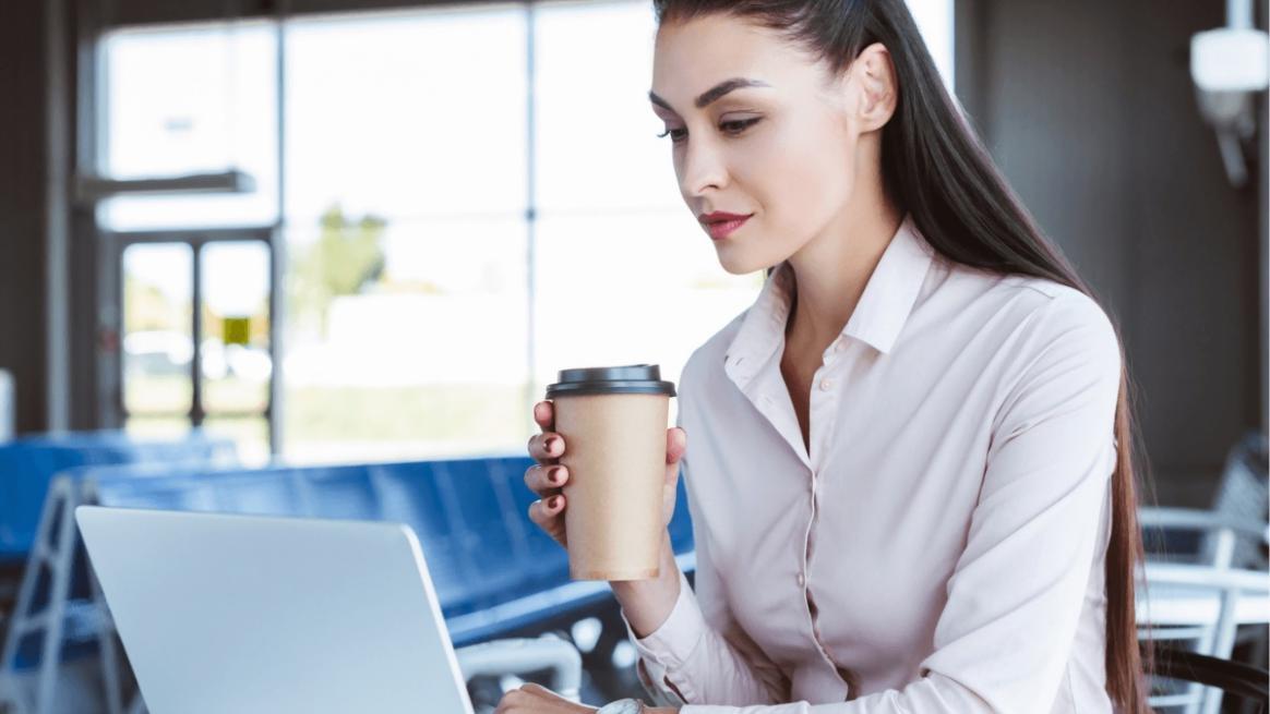 Campaign organizer reviewing budget documents with laptop and charts